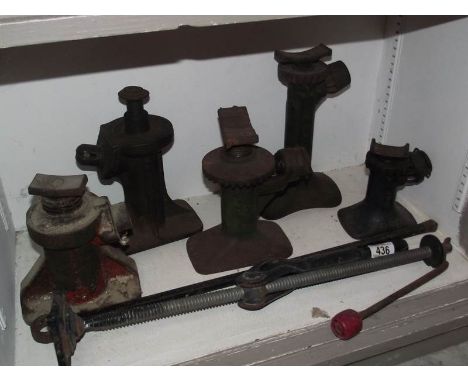 5 vintage bottle jacks and one other.