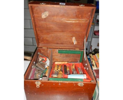 A wooden box of tools including wood chisels, plane, clamps etc.,
