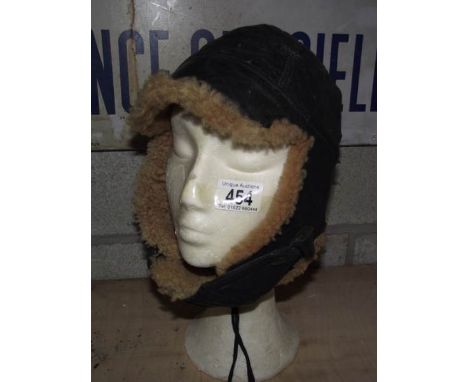 A vintage sheepskin motoring helmet with chin cover (head not included).