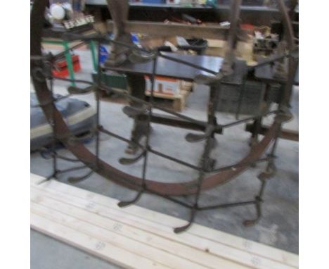 A vintage farming implement, harrow/tiller?