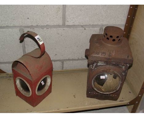 A cast iron railway lamp and a vintage road works lamp.