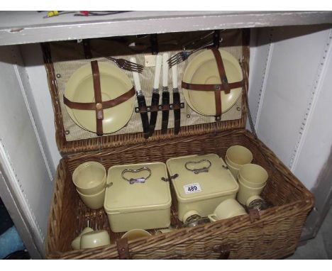 A vintage coracle picnic hamper in wicker basket.
