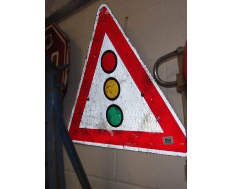 A metal traffic light warning triangle metal road sign.