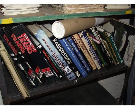 A shelf of books on railways including posters.