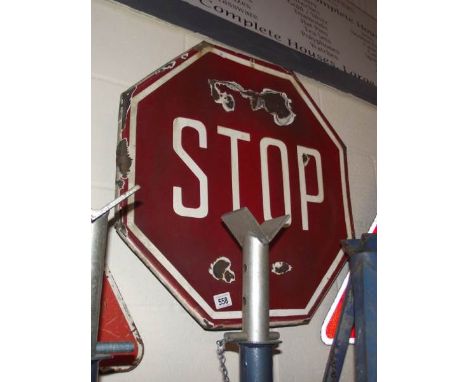 An enamel 'Stop' road sign.