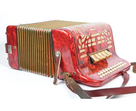 Hohner - A German Hohner Amatona IV button musical instrument accordion DeLuxe. Having a red marble effect decoration with fa