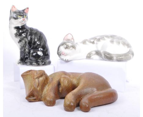 A collection of three large mid 20th century studio pottery cat figures. The collection to include a stoneware decorative sle
