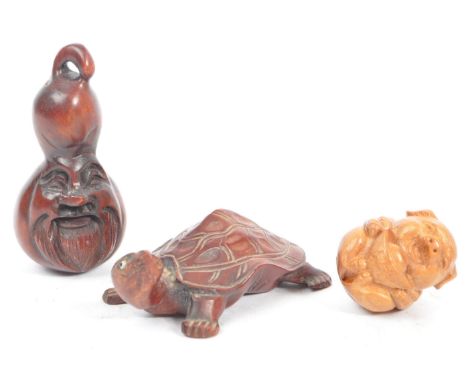 A collection of 19th century Japanese netsuke carved fruit wood figures. Comprising of a carved face, a wooden pig and tortoi