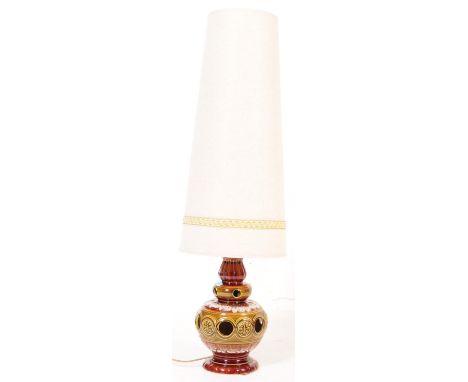 A vintage mid 20th century West German studio pottery lamp base with cream colour conical fabric lampshade. The base of the l