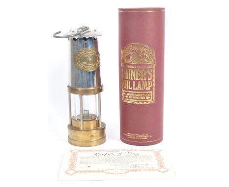 A vintage 'British Coal Mining Company Wales UK', brass and steel safety paraffin oil lamp with hanging hook atop. The brass 