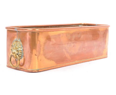A 19th century Victorian copper lion's head planter. The planter of rectangular form, with a rolled edge to rim, having lions