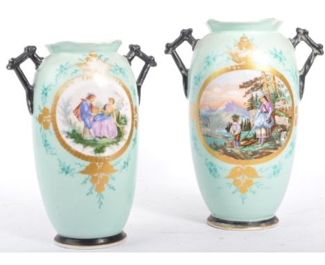 A pair of 19th century Victorian Staffordshire mantel / table vases. Having a shaped rim, twin handle in a circular body atop