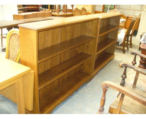 A Pair of medium oak light bookcases each with two enclosed shelves.