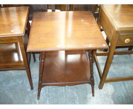 An Early 20th Century walnut occasional table with outset turned supports.