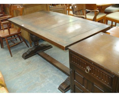 A Mid 20th century oak refectory table on two leaf carved vase shaped supports.