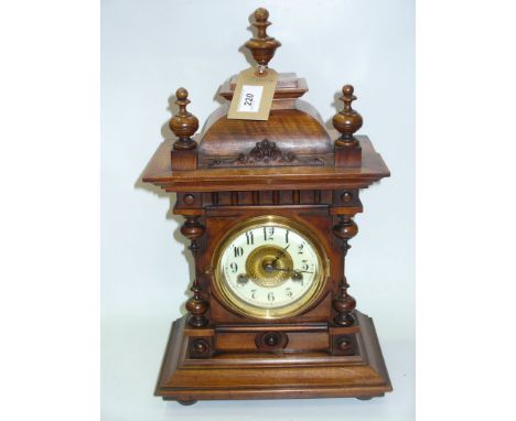 A Victorian walnut bracket clock with an enamelled dial and two train movement.