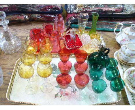 A collection of coloured glass items including a Mary Gregory style cranberry glass vase, cranberry glass jugs, ruby glass di