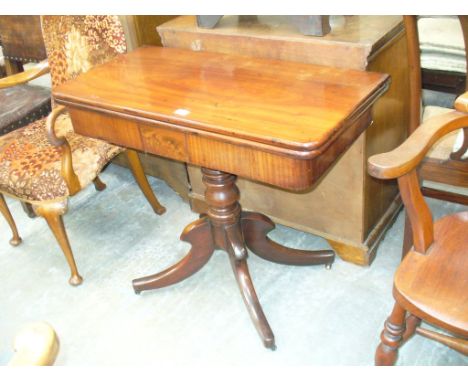 A 19th Century mahogany folding tea table on a baluster shaft and 4 down swept supports.