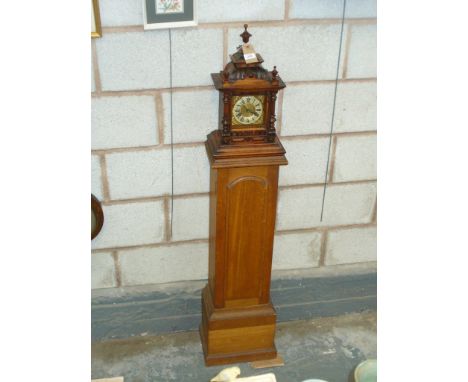A Victorian walnut bracket clock with an architectural case, silvered dial ,two train movement and raised on an oak pedestal.