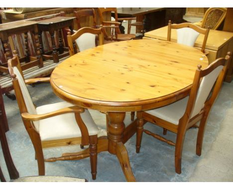 A Modern pine pedestal kitchen table with four conforming chairs.