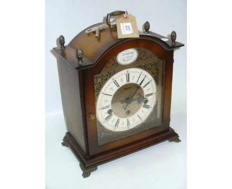 A Reproduction German bracket clock by Hermle with a three train movement, silvered dial.