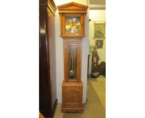 A modern light oak 8 day Westminster chime long case clock