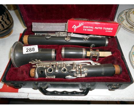Cased clarinet with tutorial book, Hohner pocket pal harmonica and fender digital auto tuner