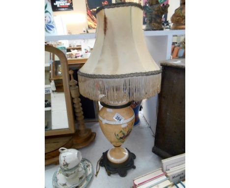 A Victorian handpainted table lamp with a metal base and silk shade