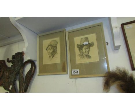 A pair of framed and glazed Tibetan portrait prints signed by the artist G Douglas