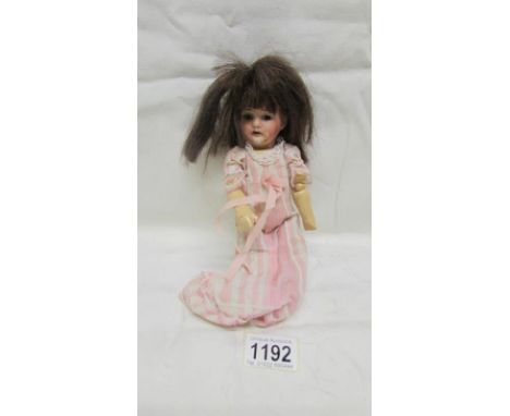 A 19th century German bisque headed doll marked 21 Germany RA