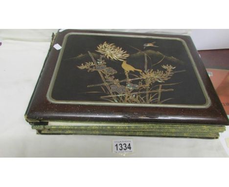 A lacquered Oriental design album with mother of pearl decoration a/f containing in excess of 50 postcards