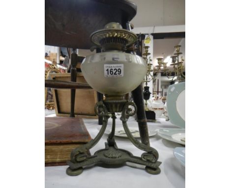 An ornate Victorian oil lamp base with cut glass font