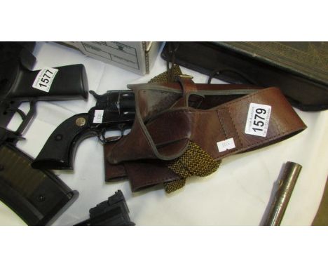 A single action army .45 replica gun with holster