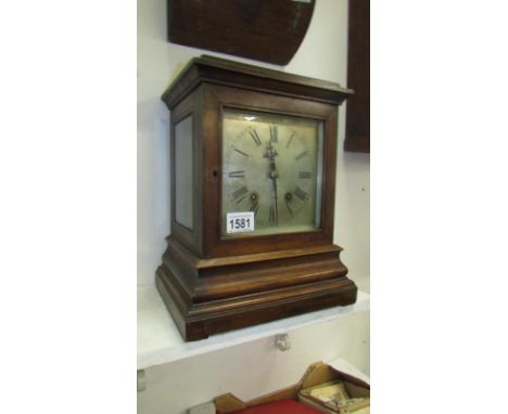 A bracket clock with bevelled glass sides, spring and feather ok