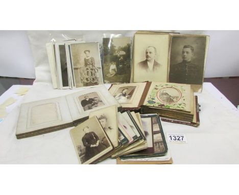 2 small photograph albums with contents along with a quantity of Victorian / early 20th century portrait photographs and post