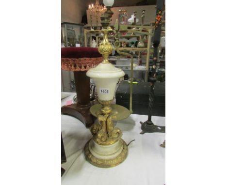 A white marble table lamp base with gilt metal plinth and mythical fish column