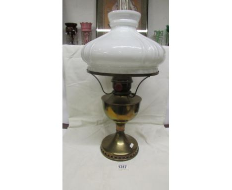 A brass oil lamp complete with opaque mushroom shade and chimney