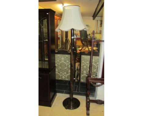 A oriental carved standard lamp with shade