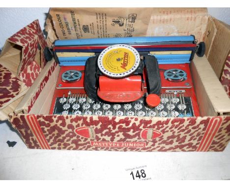 A boxed Mettoy Mettype portable typewriter