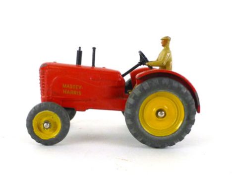 A Dinky Toys Massey Harris tractor 27A with driver painted red body and yellow hubs  CONDITION REPORT: Chips to paint some we
