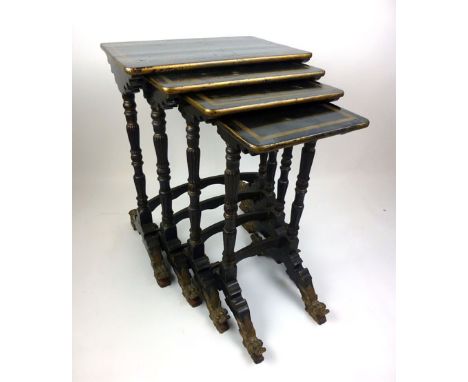 A 19th century Chinese black lacquered and parcel gilt quartetto nest of tables on turned reeded legs over carved dragon feet