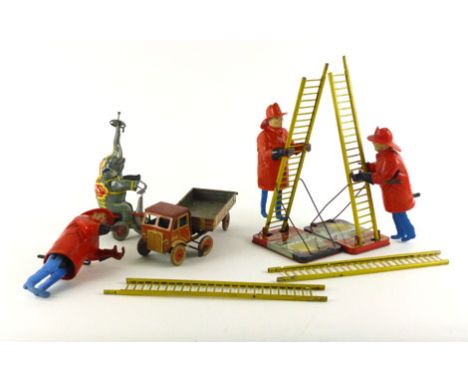 A collection of tinplate wind up toys comprising of two ladder climbing firemen (and one for parts) a circus elephant and tru