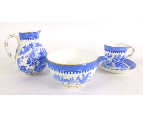 A Royal Worcester coffee cup and saucer, together with pouring jug and sugar bowl, decorated in a blue and white 'Willow' sty