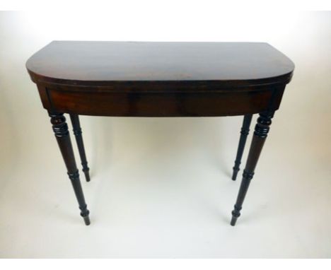 A late 18th century mahogany and ebony line inlaid card table, the fold over top with later insert supported on four turned l