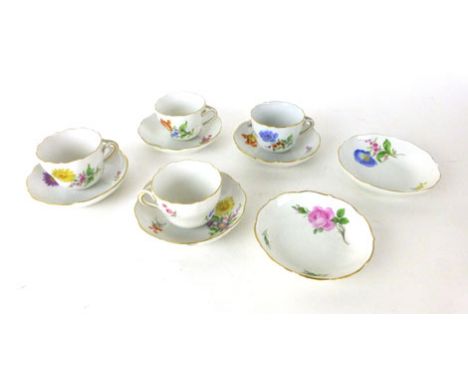 Four floral decorated and gilt edged cups with crossed sword marks underneath, together with six matching saucers 