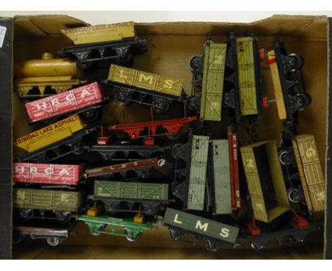 A collection of Hornby series tin plate model railway carriages to include Esso oil tanker, timber transporter etc 