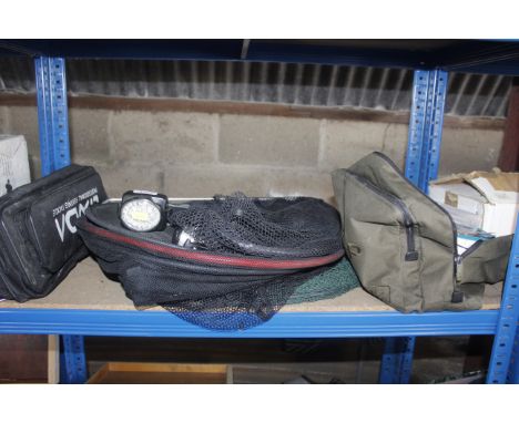 A collection of fishing nets, a reel, head torch, bag of tackle