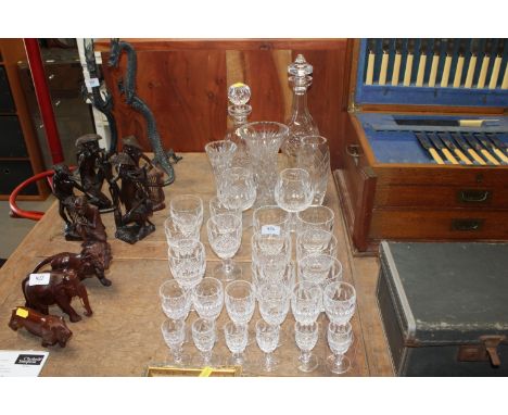A collection of Waterford cut glass ware to include tumblers, wines, liquors, brandy balloons, three vases and two decanters
