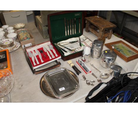 A Picquot ware three piece tea set, various cutlery etc.