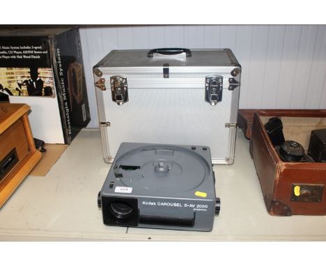 A Kodak Carousel S-AV2050 projector and a metal camera carrying case